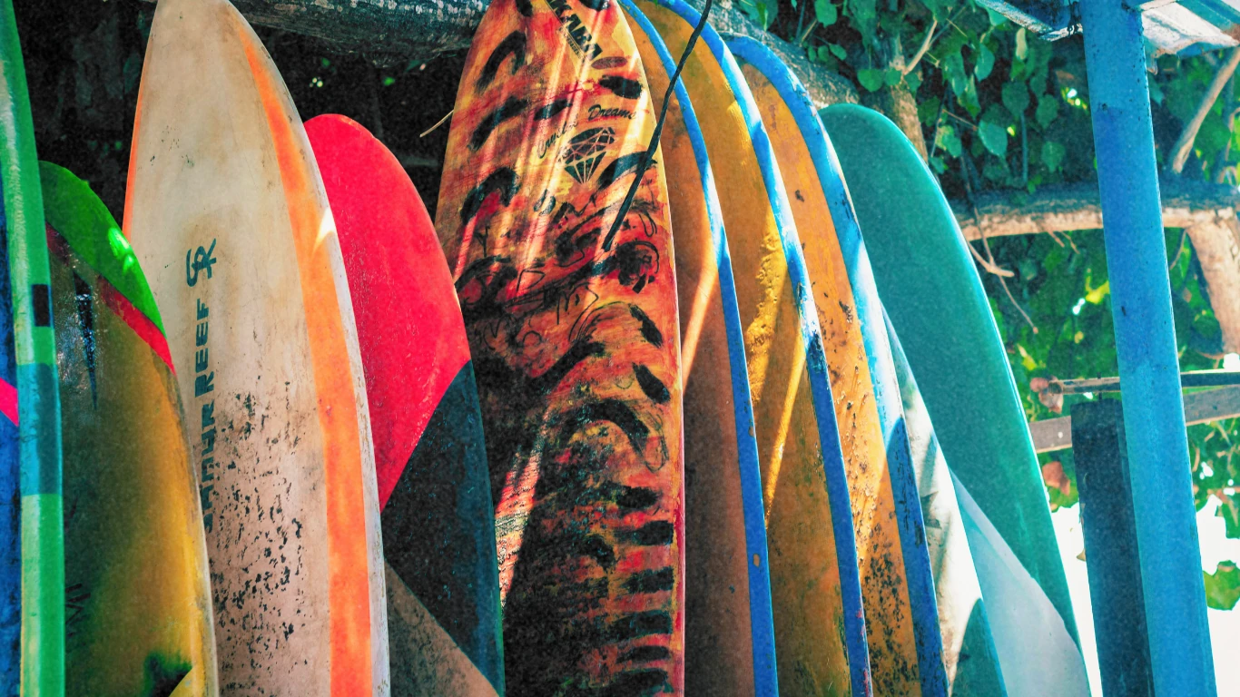 Stacked colourful surfboards