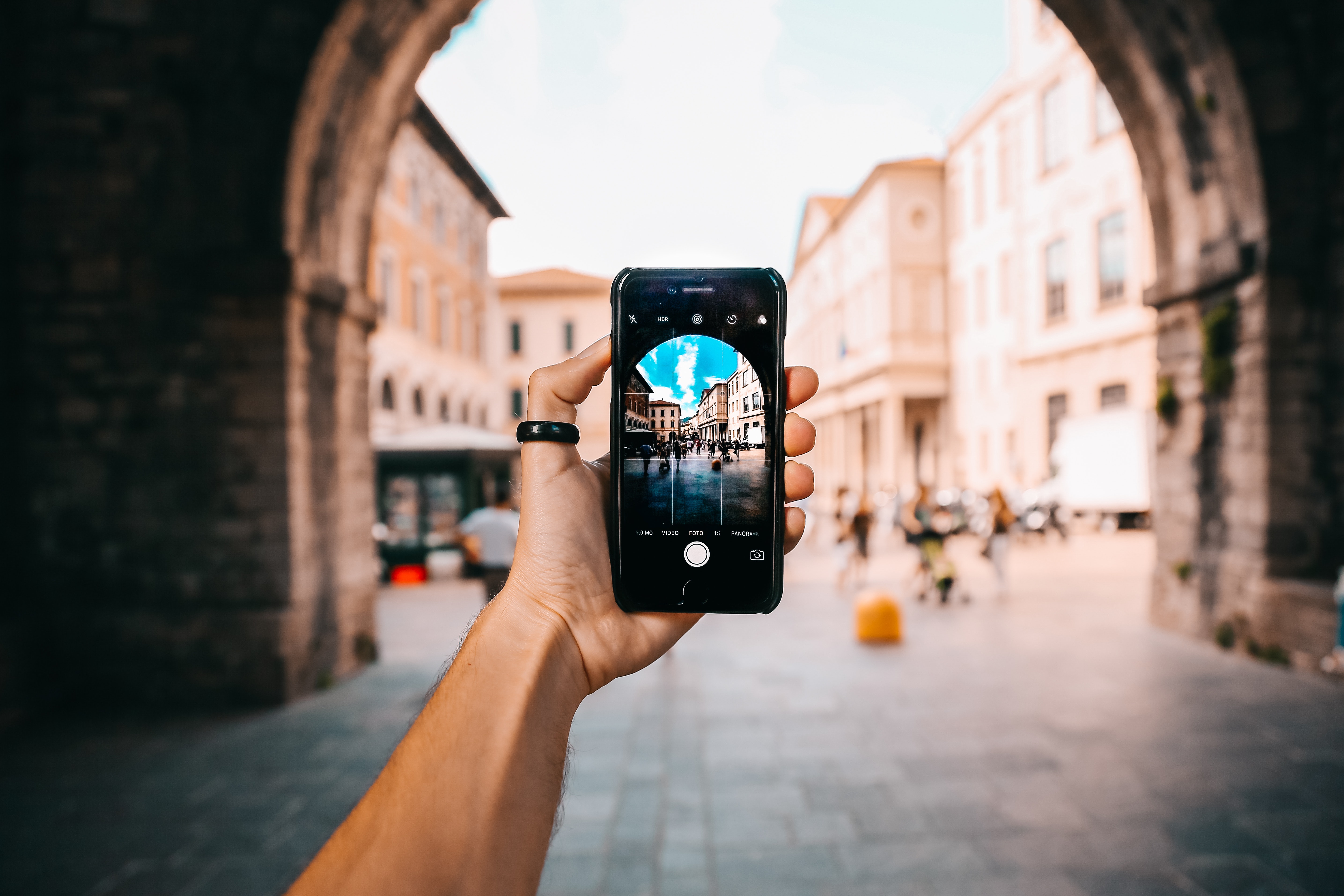 Taking a picture of Italy with a smartphone for social media marketing