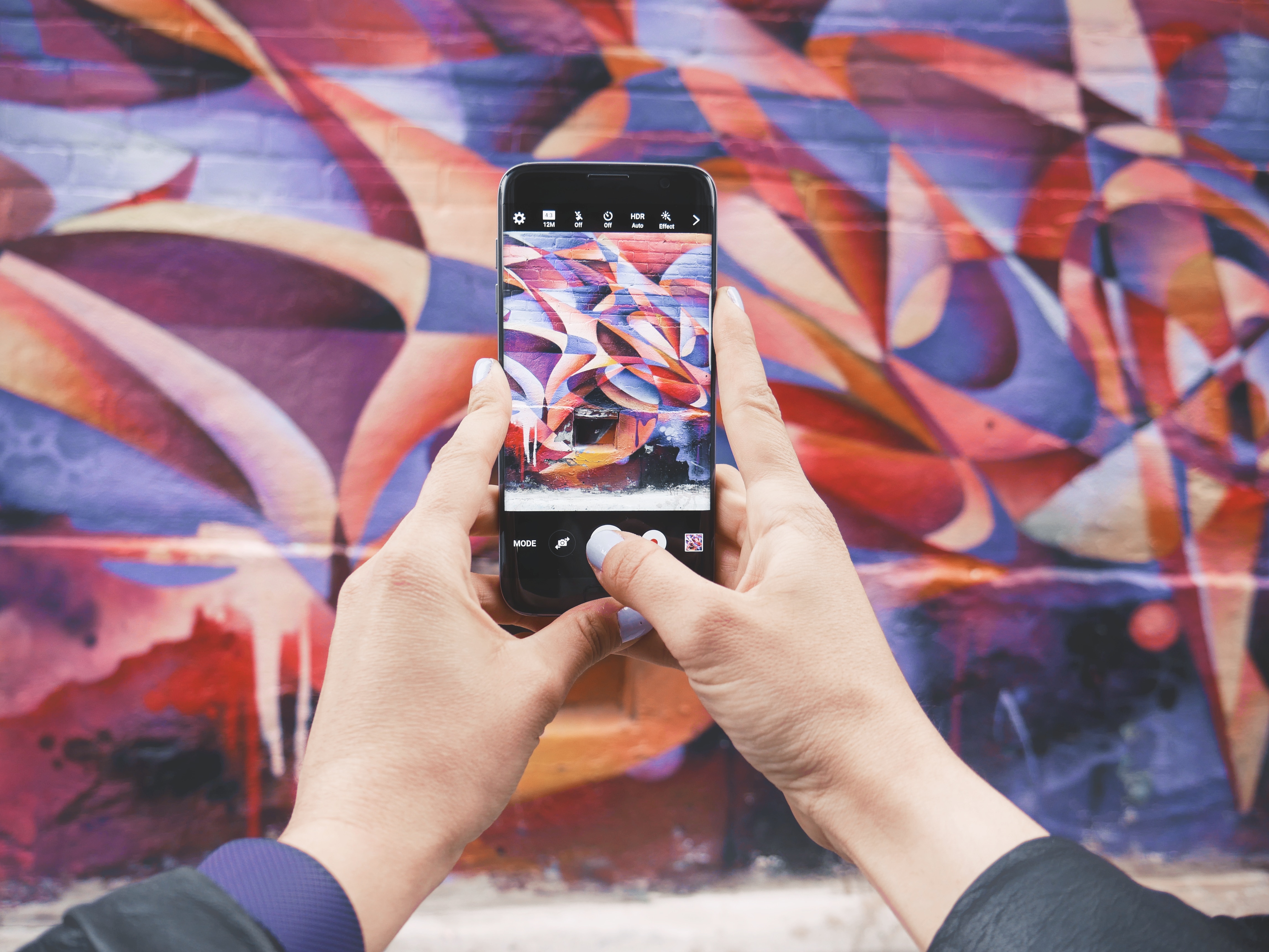 Taking a picture of graffiti with a smartphone for social media marketing